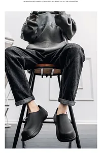 Detail view of black waterproof chef shoes on model with non-slip sole and thick sole