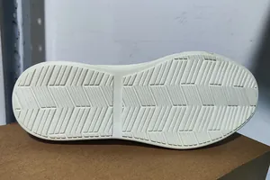Detailed macro view of beige anti-slip rubber sole with herringbone traction pattern