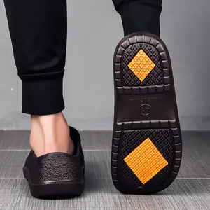 Macro detail of anti-slip kitchen clog sole featuring orange grip pads and traction texture