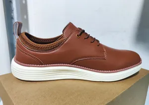 Detail of brown faux leather casual oxfords with white rippled sole and contrast stitching