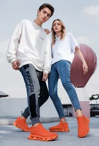 Detail of orange knitted slip-on sneakers with geometric hollow shock-absorbing soles