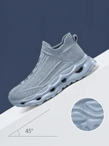 Detail of wave-shaped hollow sole and anti-slip texture on light blue knitted sneaker