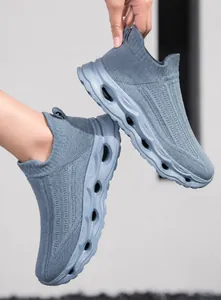 Macro detail of breathable fly-knit mesh and chunky wave-patterned thick sole