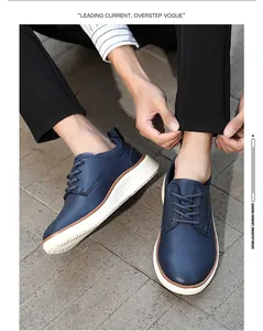 On-foot view of dark blue casual leather oxfords with thick white soles on pavement