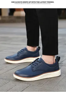 Detail of navy leather oxford shoes with textured uppers and white ripple soles