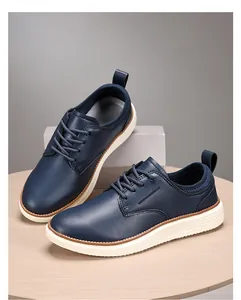 Detailed view of dark blue casual leather shoes with thick white soles and pull tabs