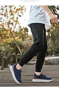 Close-up of breathable blue mesh men's walking shoes on a wooden park path