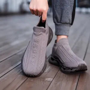 Detail view of khaki knit sock sneaker featuring the SPORT logo on a thick wavy sole