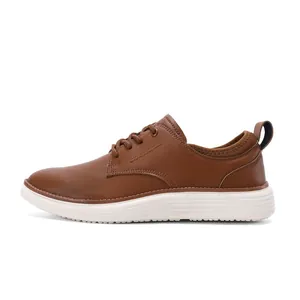 Detailed side view of brown leather oxford shoes with a modern thick white rubber sole
