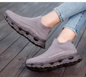 On-foot view of breathable grey knit slip-on sneakers with chunky hollow shock-absorbing sole