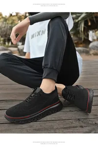 Detail of lightweight black mesh men's shoes with breathable fabric and red line accents