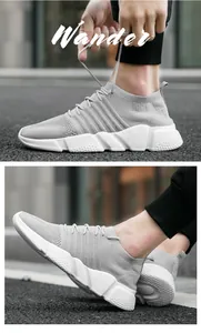 Gros plan de baskets en maille gris clair avec lacets texturés et semelles blanches