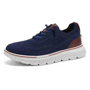 Men's navy knit loafers with thick white soles and brown leather details