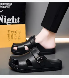 Detail of black leather texture and breathable side vents on mens clog sandals