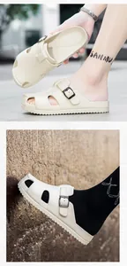 Detail view of beige clogs with adjustable buckle and breathable ventilation holes