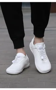 Detail of white barefoot shoes showing breathable mesh and elastic drawstring laces