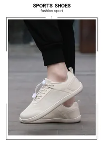 Detail view of beige knit sports shoes with quick-lace toggle on outdoor tiles