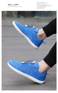 Detailed close-up of blue wide-toe barefoot sneakers with knit upper and speed lacing