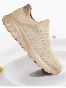 Macro view of khaki slip-on walking shoes featuring breathable knitted mesh upper