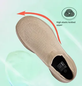 Detail of breathable knitted mesh fabric showing elastic stretch on beige slip-on shoes
