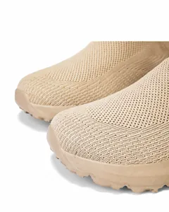 Detail view of khaki knit slip-on sneaker featuring high elastic fabric and wide toe box