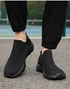 Detail of black mesh breathable slip-on sneakers with thick sole and seamless knit fabric