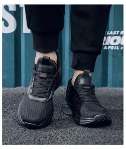 On-foot shot of black breathable mesh running shoes with thick cushioned soles in street setting