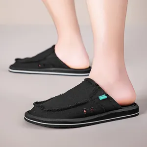 Men's breathable canvas slip-on mules in black with frayed edges and striped rubber soles