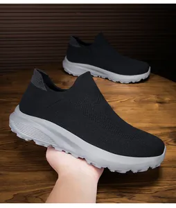 Detail of breathable knitted mesh fabric and slip-on design on black men sneakers