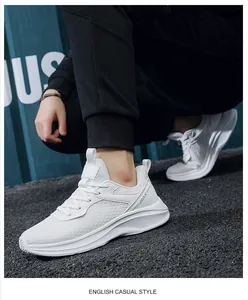 Detail view of white breathable mesh sneakers with thick soles and side JGAK lettering
