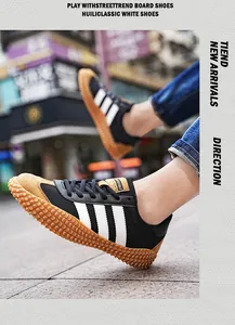 Detail view of black athletic sneakers featuring classic white stripes and gum rubber soles