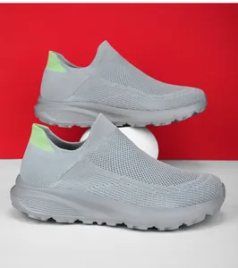 Detail of breathable gray woven slip-on sneaker with vibrant neon green heel pull tab