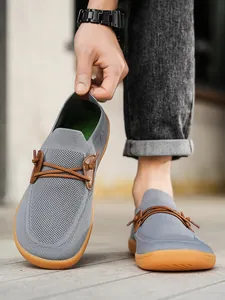 Detailed close-up of grey mesh barefoot shoe showing flexible upper and breathable fabric