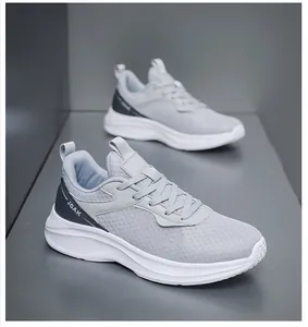 Detail of breathable mesh upper and JGAK logo on grey lightweight running shoes