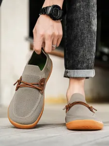 Detailed view of breathable khaki knit fabric and wide toe design on casual men shoes