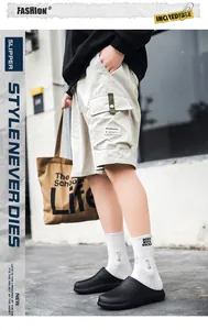 Outdoor street style view of non-slip EVA kitchen clogs paired with cargo shorts
