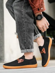 Men's breathable black mesh loafers with vibrant orange rubber soles and street style details