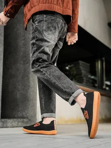 Outdoor dynamic shot of black breathable mesh men's shoes with brown rubber sole and details