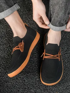 Top view of men's wide-toe mesh sneakers showing breathable fabric and slip-on design