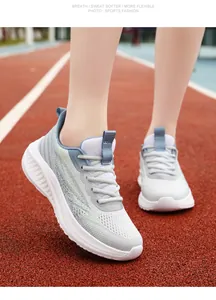 Breathable mesh running shoes for men and women on a red track background