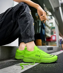 Seitenansicht neongrüner Mesh-Laufschuhe mit dicker Sohle und Schnürung im Streetwear-Stil