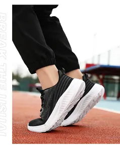 Men's running shoes with breathable knit upper and thick cushioned soles on athletic track