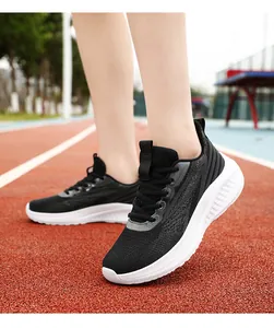 Breathable black mesh running shoes with thick white cushioning soles on track