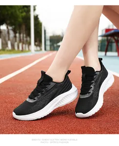 On-track view of black breathable mesh running shoes with thick white cushioned soles