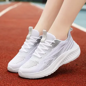 Breathable white mesh running shoes with silver stripes on a red athletic track