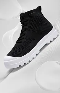 Detailed close-up of breathable mesh fabric and high-top knitted design on black sneakers