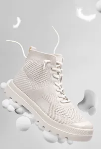 Detail of breathable knitted high-top mesh sneakers featuring lightweight non-slip sole