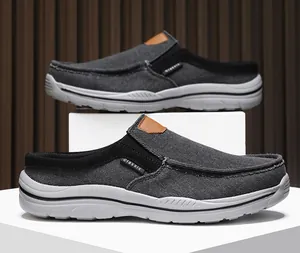 Detail of dark grey canvas mule sneakers with classic tag and thick rubber sole