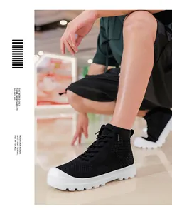 Detail shot of breathable black mesh high-top sneakers with white anti-slip thick soles