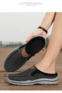 Detail of grey denim mules for men with classic leather trim and non-slip rubber soles